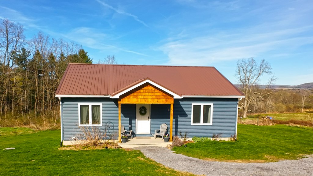Scenic views over the Brooktondale hillsides with this newer modern ranch home on 6 acres in Ithaca Schools! Open floor plan with vaulted ceilings in the living room/kitchen and dining area. Lots of Southern light fills this open space throughout the day. Sliding doors lead to 9'x16' back deck offering privacy and pond views. There are 2 bedrooms and 1 full bath on the main floor with an oversized entry hall and laundry space. Lower level is finished with 2 more bedrooms and 2nd full bath, hobby/craft area with dry bar/sink and rec room. There's also an easy walk-out to backyard plus a mechanical/storage room. Radiant in-floor heating and on-demand water heater add to the modern conveniences. Room to add your garage but plenty of off-street parking. Don't miss the picnic pavilion/gazebo by pond offering nice covered space throughout the seasons! Ample garden areas too. Only a few minutes to either downtown Ithaca or the Hamlet of Brooktondale, quick commute to Cornell University or Ithaca College. Natural areas nearby include Six Mile Creek off Middaugh Road, Eldridge Wilderness Preserve off Troy Road or South Hill Recreation Way off Burns Road. Enjoy living the Ithaca lifestyle with views and space all around you! Any/all offers to be submitted by 11am on Wednesday April 30, 2025.